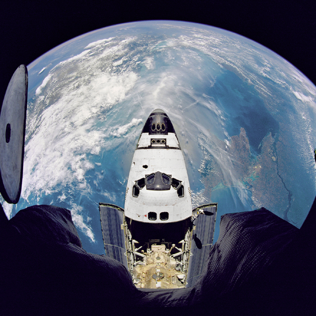 Fish eye view of Space Shuttle Atlantis (STS-71) from Russian Mir Space Station. Image courtesy of NASA.